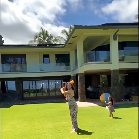 Lauren Hashian playing with her husband and children at her house.